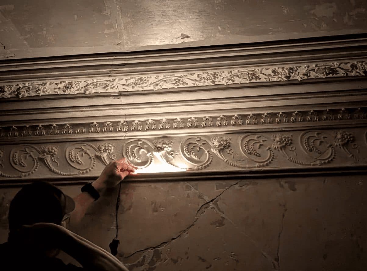 Examining a plaster cornice profile by raking light