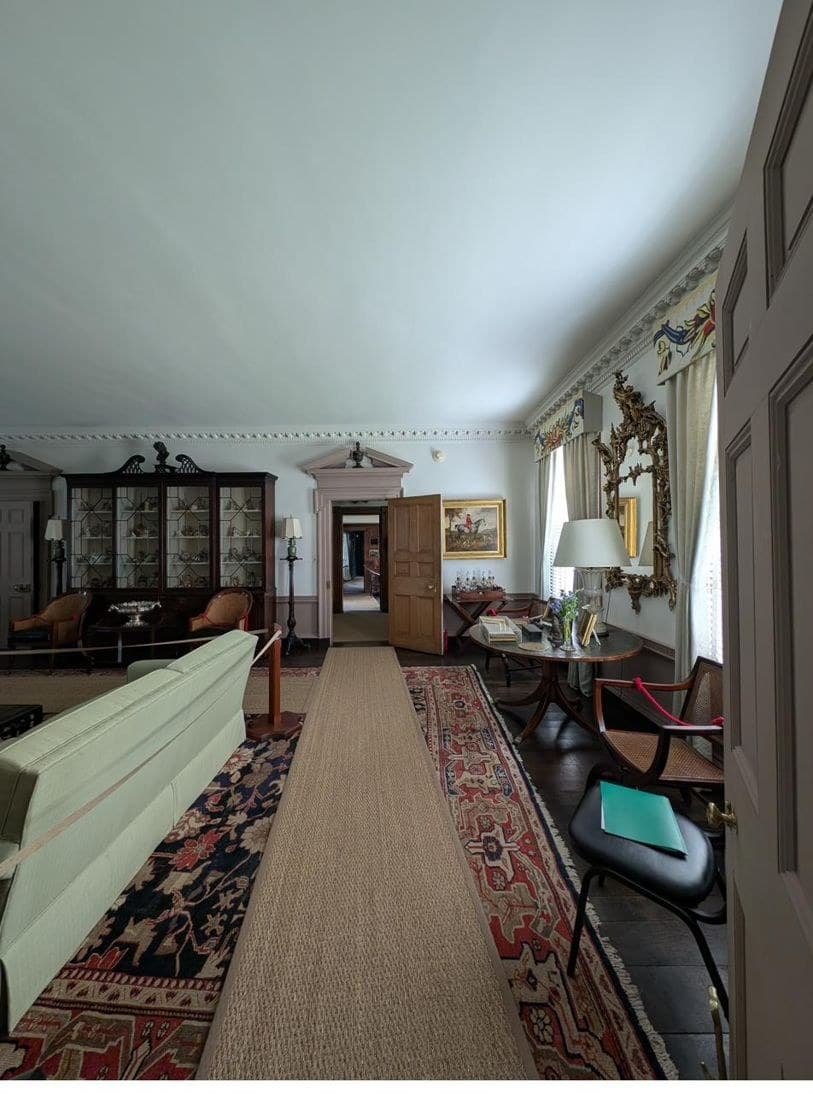 The drawing room, its principal double-hung sashes setting the room's rhythm
