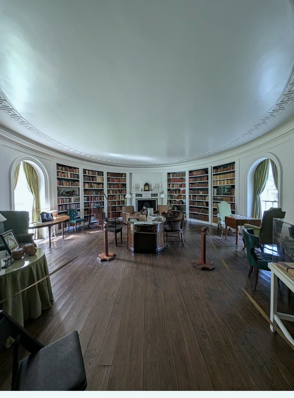 The Oval Library, its curved wall carrying the Palladian pair