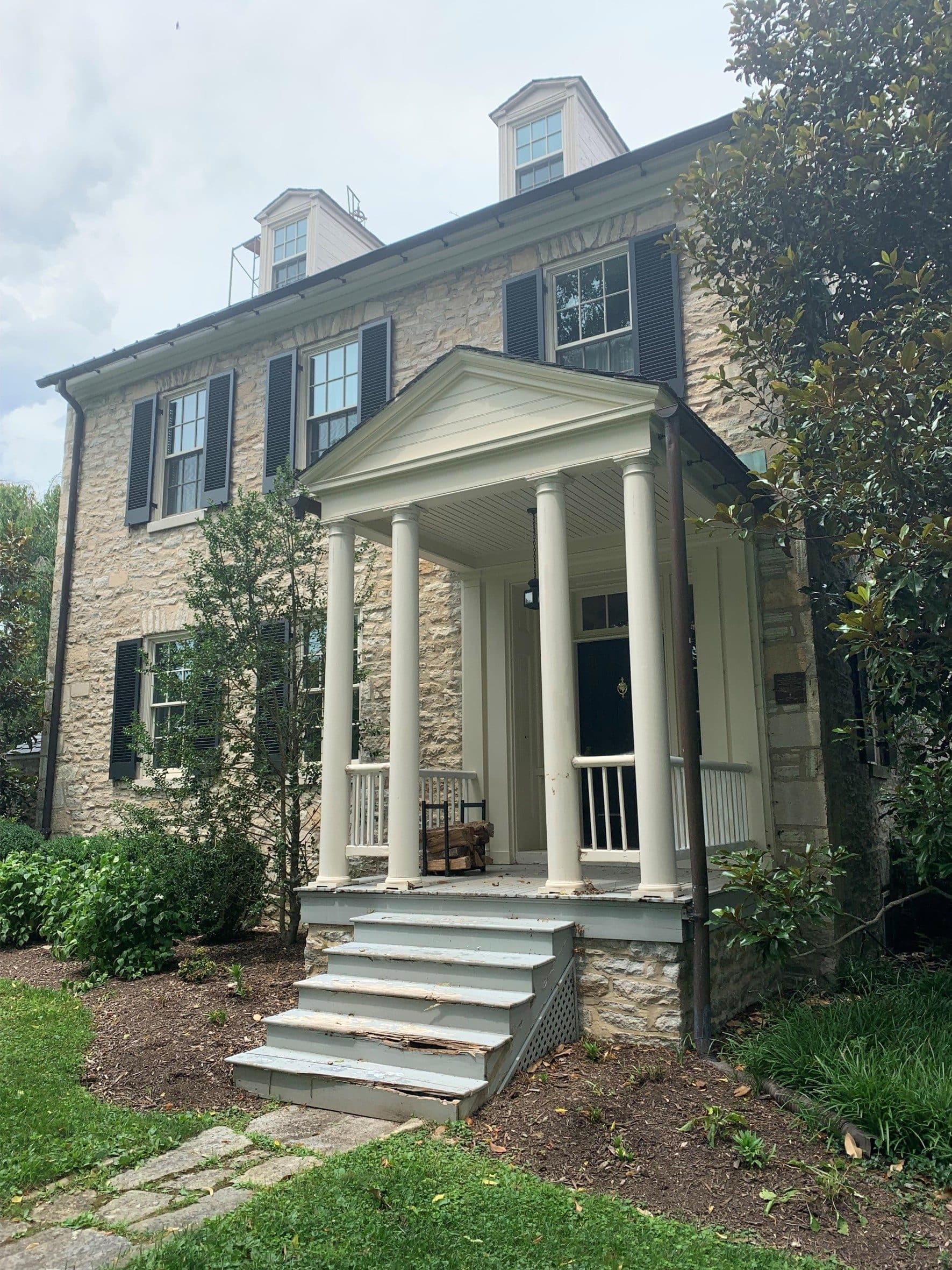 The stone rectory with its columned portico
