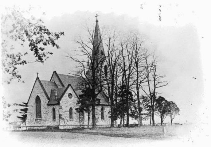 Historic photograph of the church among mature trees
